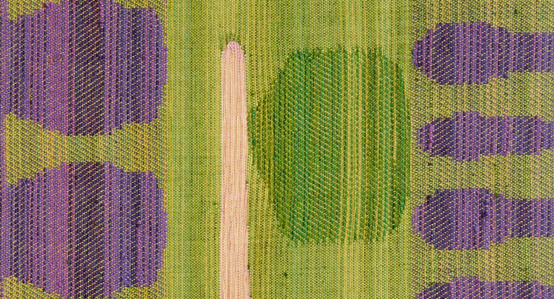 Kuvassa kudotun tekstiilitaideteoksen pintaa.