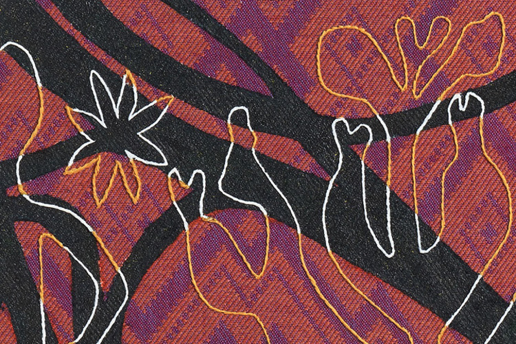 n the picture there is a close up picture of the artwork that is woven, embroidered and painted.