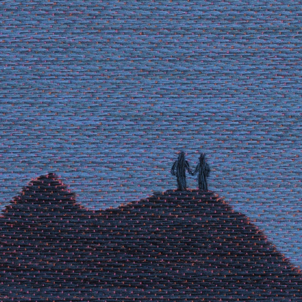 A close-up of the surface of the textile artwork in such a way that the woven binding of the fabric and the embroidered human figures are visible.